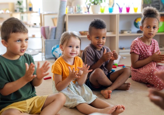 group-of-small-nursery A group of children sit and listen to their teacher at Embrace Life Child Care, which offers outstanding Child Care by Brimfield IL.