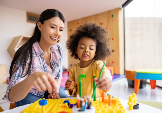happy-teacher A teacher smiles while helping a child work on a project at Embrace Life Child Care, which is a top Preschool Near You when you're in the Edwards IL area.