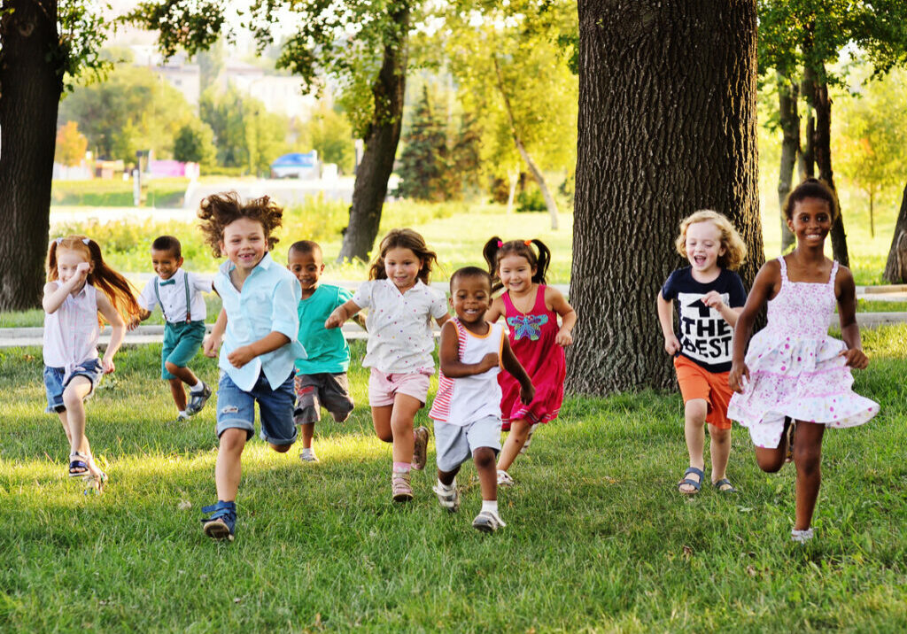 A group of preschoolers running and playing outside